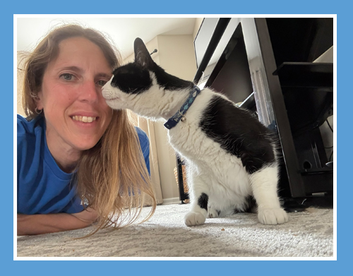 Regina from Pawsome Help cuddling a cat during a pet sitting visit